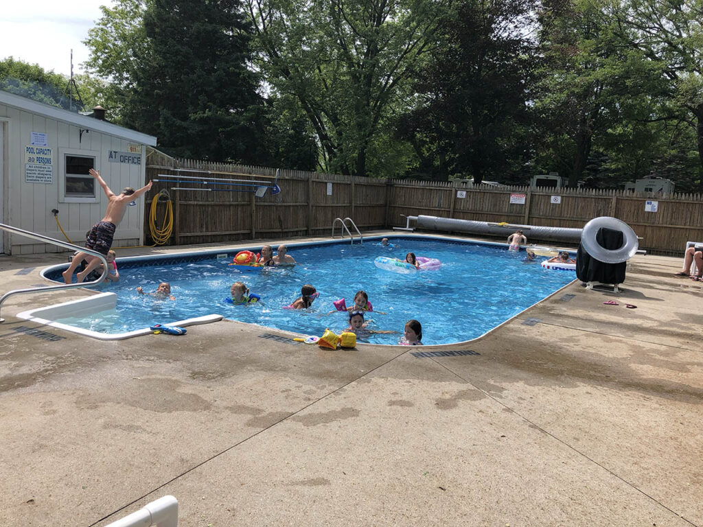 Kids enjoying the heated pool. One kid is jumping in